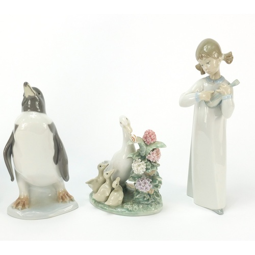 770 - Collectable china including Lladro penguin and figurine of a girl holding an instrument, the largest... 