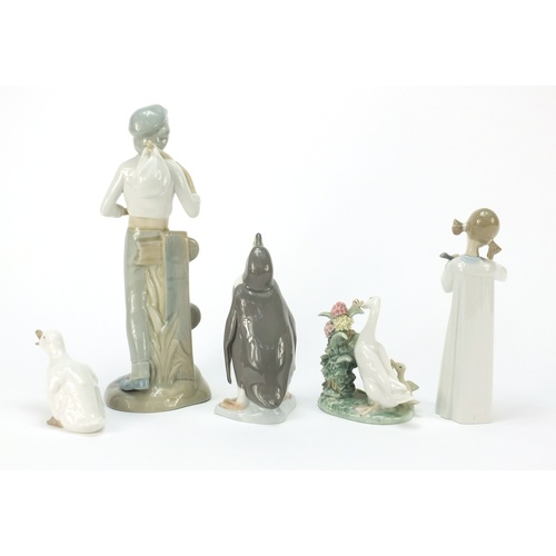 770 - Collectable china including Lladro penguin and figurine of a girl holding an instrument, the largest... 