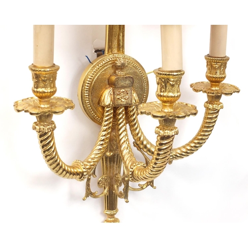 115 - Pair of Louis XVI style three branch brass wall sconces with shades, 67cm high