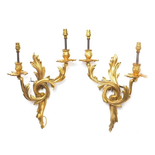 31 - Pair of Rococo style two branch brass wall sconces, 45cm high