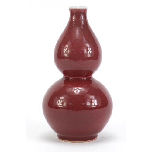 76 - Chinese porcelain sang de boeuf glazed vase of double gourd form, 21.5cm high