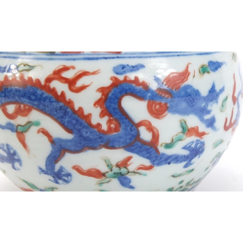 77 - Chinese porcelain wucai pot, hand painted with dragons amongst clouds chasing flaming pearl, six fig... 