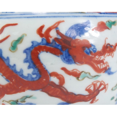 77 - Chinese porcelain wucai pot, hand painted with dragons amongst clouds chasing flaming pearl, six fig... 