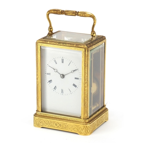 23 - 19th century brass cased carriage clock striking on a bell having an enamelled dial with Roman numer... 