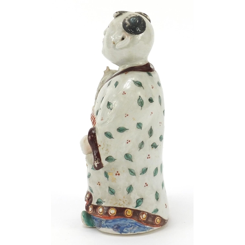 32 - Chinese porcelain figure of a boy holding a toy horse hand painted with leaves, 20.5cm high