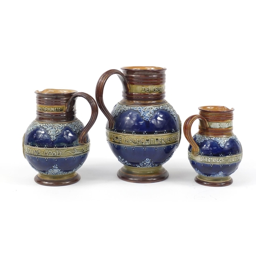 92 - Graduated set of three Doulton Lambeth Queen Victoria commemorative jugs, the largest 23.5cm high