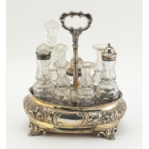 33 - Victorian silver seven bottle cruet stand by Thomas Smily, with seven glass bottles, some with silve... 