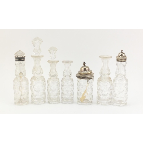 33 - Victorian silver seven bottle cruet stand by Thomas Smily, with seven glass bottles, some with silve... 