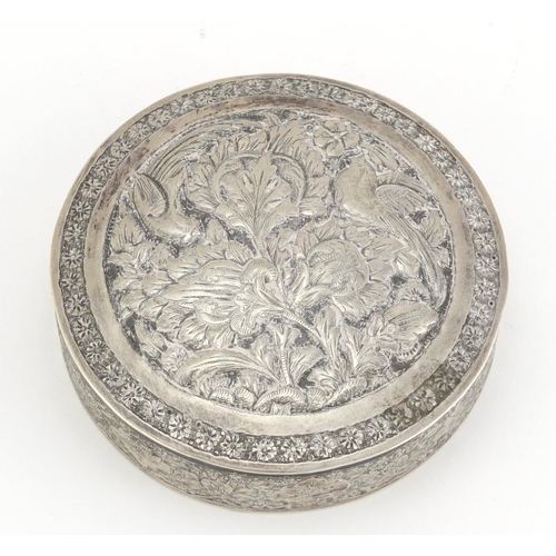 99 - Indian circular silver box and cover embossed with birds amongst foliage, impressed marks to the bas... 