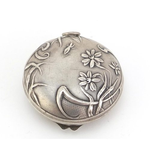 105 - Art Nouveau unmarked silver compact embossed with stylised flowers, 4.8cm in diameter, 17.5g