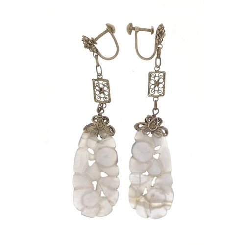 16 - Pair of Chinese white metal mounted agate earrings carved with flowers, 7.5cm in length, 9.8g