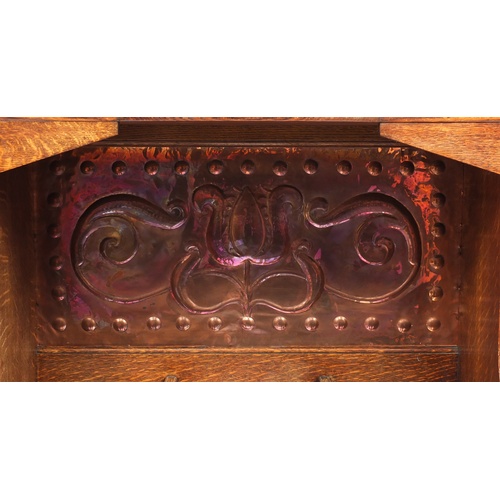 68 - Arts & Crafts oak hall stand with bevelled mirror and copper inserts to each wing, remnants of the o... 