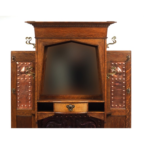 68 - Arts & Crafts oak hall stand with bevelled mirror and copper inserts to each wing, remnants of the o... 