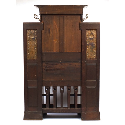 68 - Arts & Crafts oak hall stand with bevelled mirror and copper inserts to each wing, remnants of the o... 