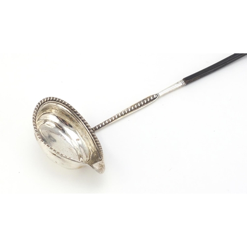 106 - Georgian unmarked silver ladle with twisted horn handle, 40cm in length