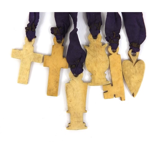 3451 - 19th century religious ivory and silk talisman, with six inscribed charms, 21cm long