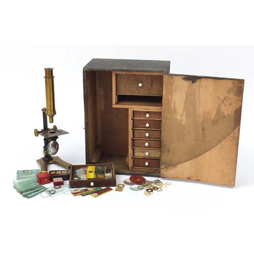 3179 - Victorian brass microscope and a small selection of student specimen glass slides, housed in a pine ... 