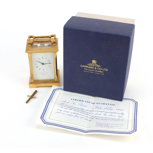 3055 - Garrard & Co brass cased carriage clock with enamelled dial having Roman numerals and box, 12cm high