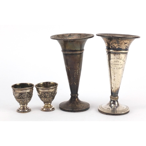 3821 - Two silver bud vases and a pair of Turkish silver egg cups, housed in a Hamilton & Inches box, the l... 