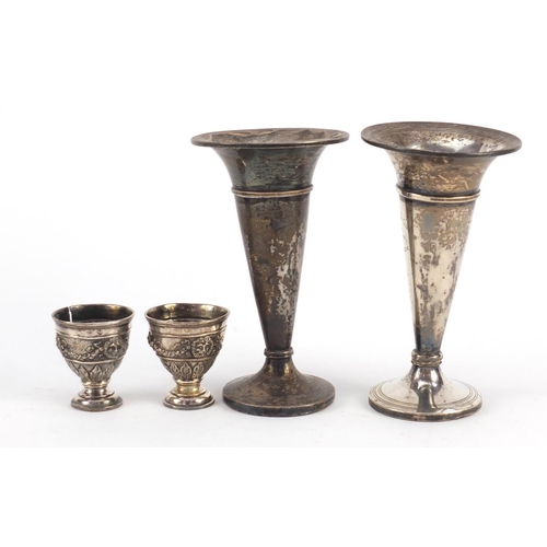 3821 - Two silver bud vases and a pair of Turkish silver egg cups, housed in a Hamilton & Inches box, the l... 