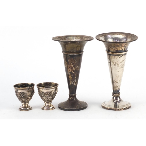 3821 - Two silver bud vases and a pair of Turkish silver egg cups, housed in a Hamilton & Inches box, the l... 