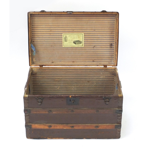 3512 - Vintage wooden bound travelling trunk with carrying handles, Whites Store label to the interior, 45.... 