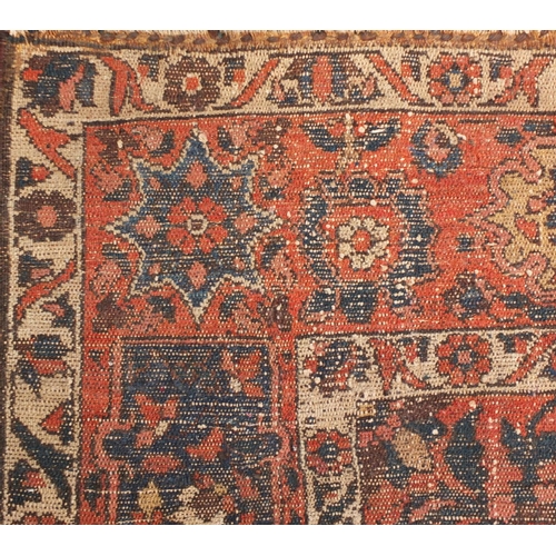 4015 - Rectangular Persian rug having an all over floral design onto a red and blue grounds, 216cm x 147cm