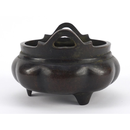 3386 - Chinese patinated bronze tripod incense burner with twin handles, character marks to the base, 10cm ... 