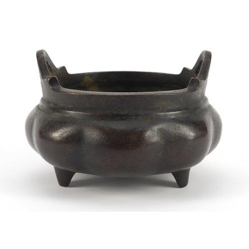 3386 - Chinese patinated bronze tripod incense burner with twin handles, character marks to the base, 10cm ... 