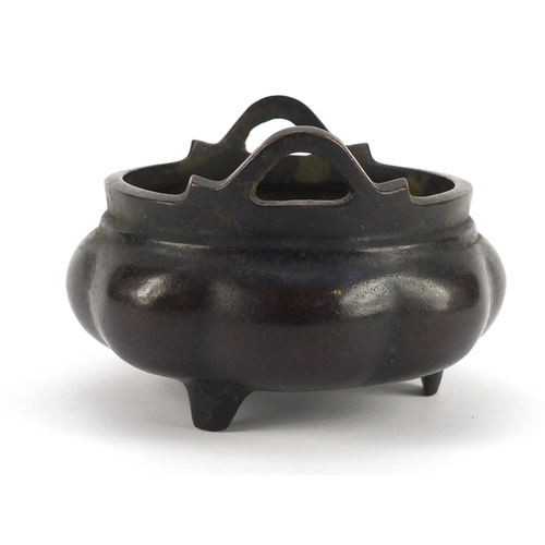 3386 - Chinese patinated bronze tripod incense burner with twin handles, character marks to the base, 10cm ... 