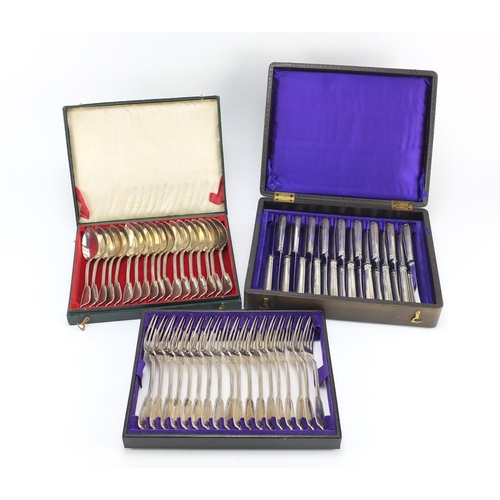 3934 - Set of eighteen German silver knives, forks and spoons, all housed in a velvet and silk lined tooled... 