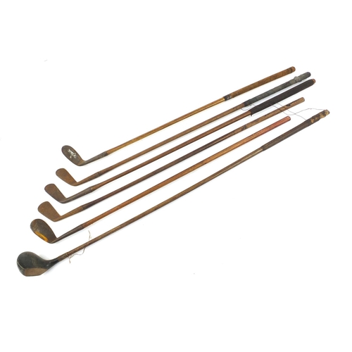 3341 - Six wooden shafted golf clubs, some with leather grips, including a driver