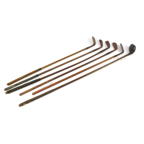 3341 - Six wooden shafted golf clubs, some with leather grips, including a driver