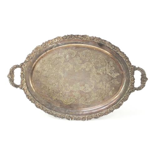 3866 - Heavy silver plated serving tray with twin handles, engraved with flowers, 69.5cm wide x 42.5cm deep