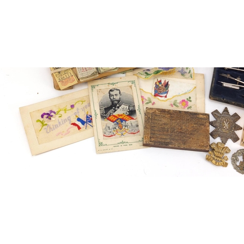 5232 - Sundry items including military cap badges, pocket lighters and bus tickets