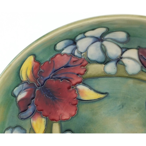 3482 - William Moorcroft pottery shallow bowl hand painted in the Orchid pattern onto a green ground, 27cm ... 