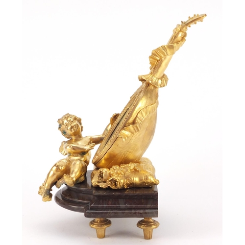 4003 - French Empire style gilt bronze table mirror in the form of putti with a mandolin, raised on a shape... 