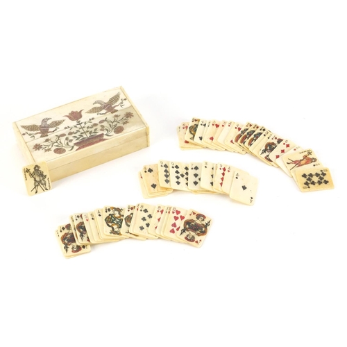 3992 - Set of carved bone playing cards housed in a box, carved with two birds and flowers, each card 3.1cm... 