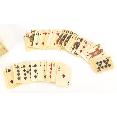 3992 - Set of carved bone playing cards housed in a box, carved with two birds and flowers, each card 3.1cm... 