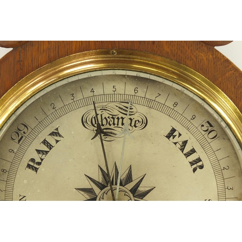 3059 - Negretti & Zambra oak wall barometer with thermometer with silvered dials, numbered 19143, 82cm high