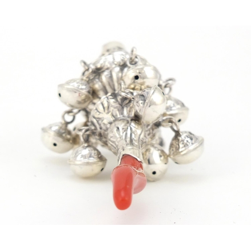 3986 - Victorian style unmarked silver babies rattle with whistle and coral handle, 14cm in length