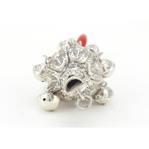 3986 - Victorian style unmarked silver babies rattle with whistle and coral handle, 14cm in length