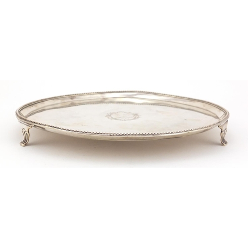 3933 - George III circular silver three footed salver, by Richard Rugg II, London 1781, 25.5cm in diameter,... 