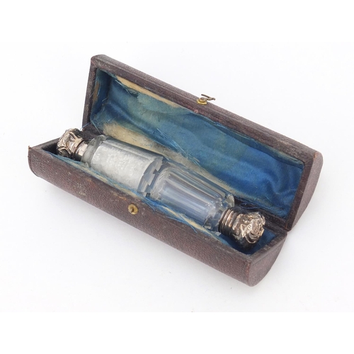 3185 - Victorian cut glass and unmarked silver double end scent bottle, housed in a leather case