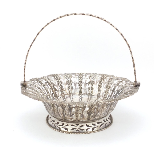 3015 - George II oval silver bread basket with swing handle, by John Langford II and John Sebille, the body... 