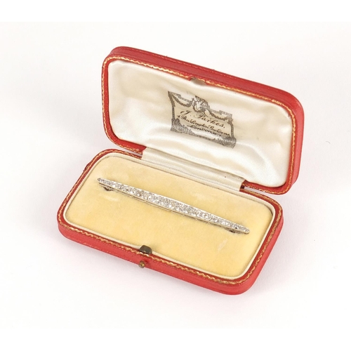 3027 - Good unmarked white metal graduated diamond bar brooch, 6.5cm in length, 4.7g, housed in a J Parks, ... 
