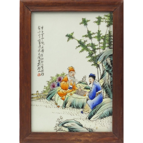 3790 - Chinese porcelain plaque housed in a hardwood frame,  hand painted with figures beside a tree with c... 