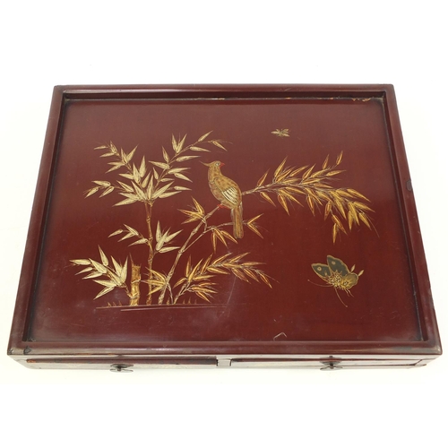 3953 - Chinese red lacquered desk stand with two drawers, gilded with bird and butterflies amongst flowers,... 