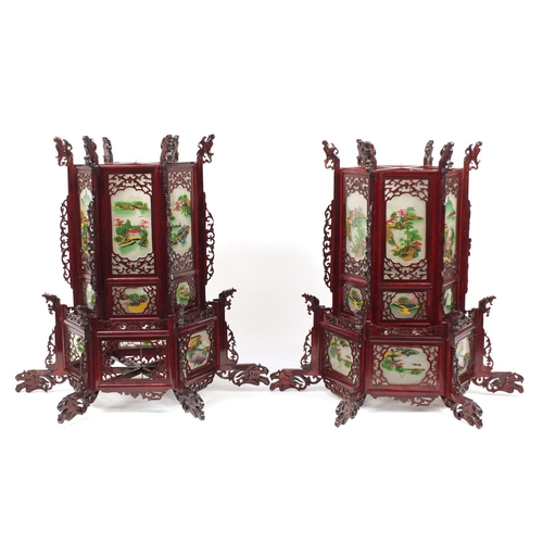 3946 - Pair of Chinese carved wood hanging lanterns with panels, each decorated with landscapes, 75cm high