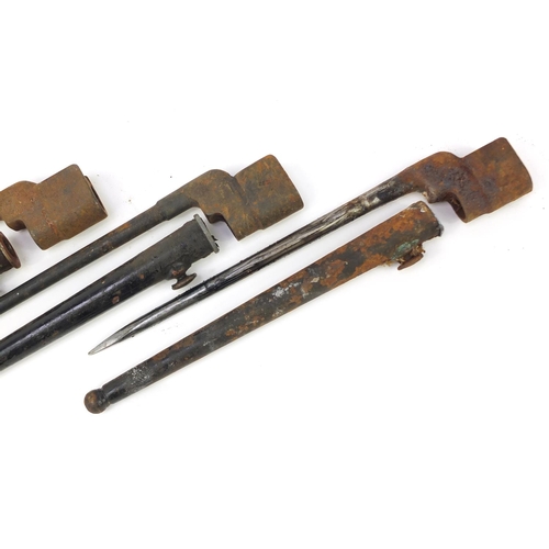 3297 - Three British military socket bayonets with scabbards, each 27.5cm in length